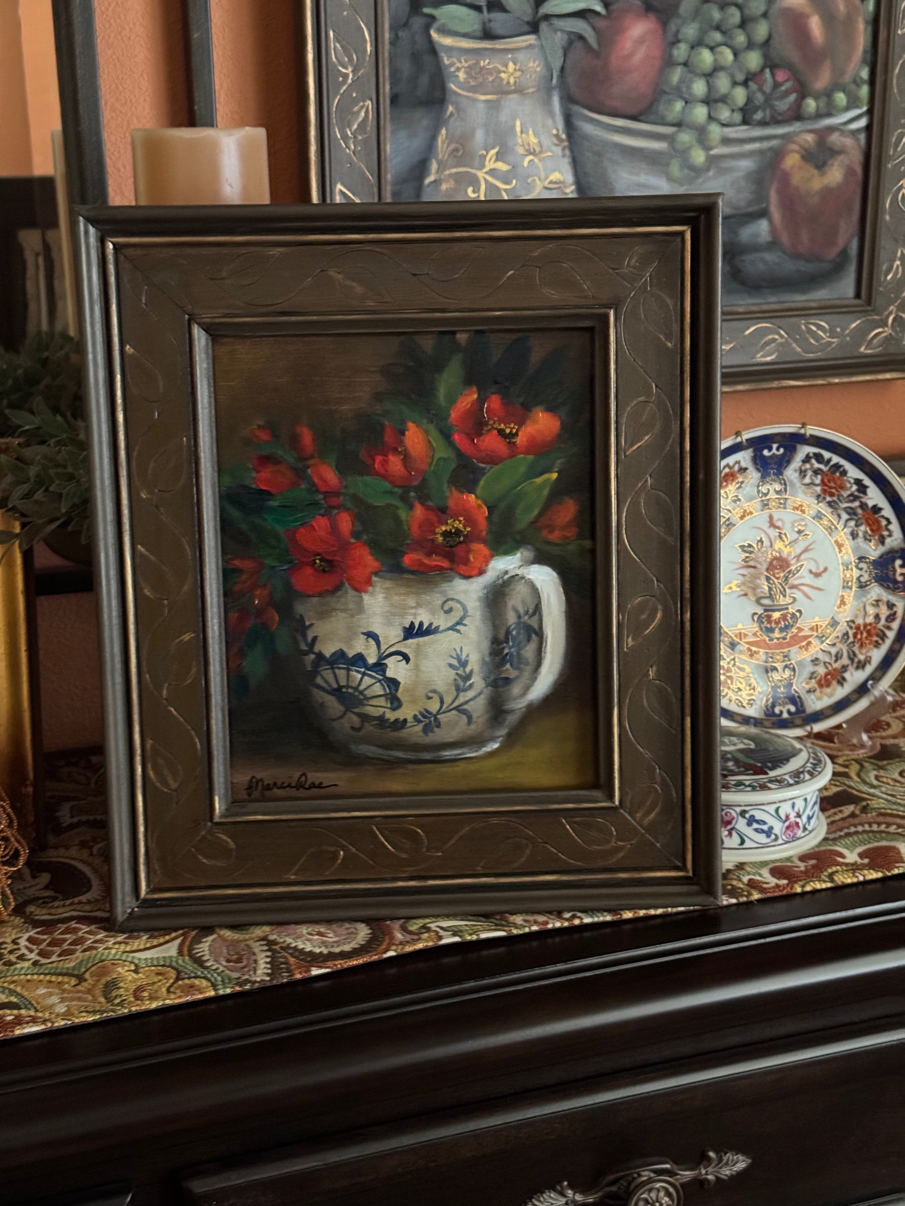 Original still life painting of red flowers in blue and white teacup with soft light