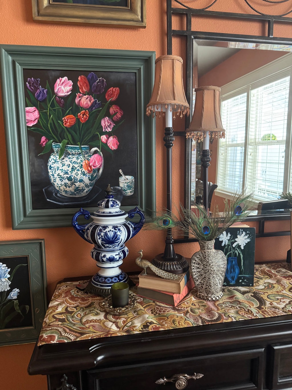 Original tulip still life painting in green and white vase, framed and displayed in styled interior setting