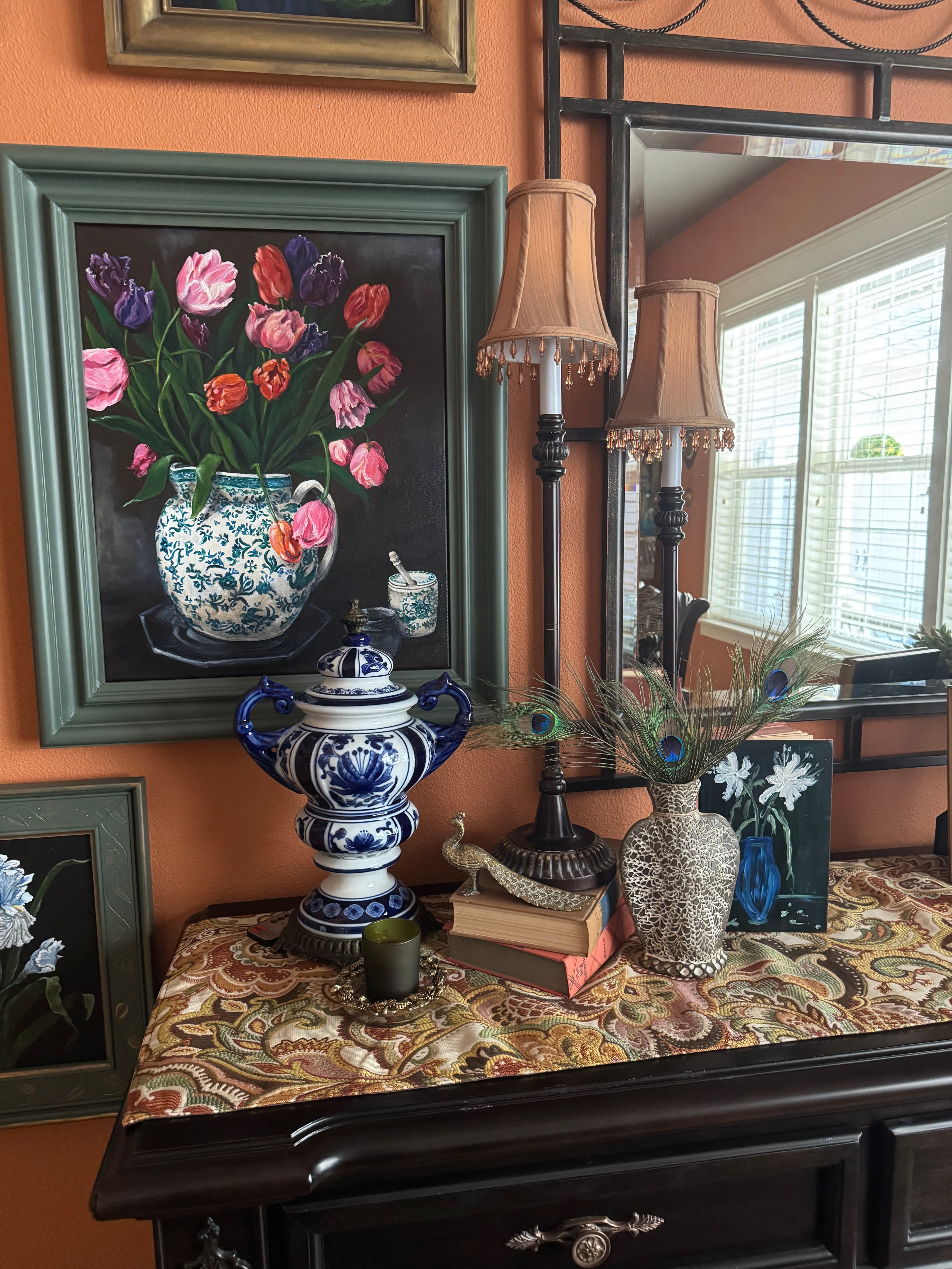 Original tulip still life painting in green and white vase, framed and displayed in styled interior setting