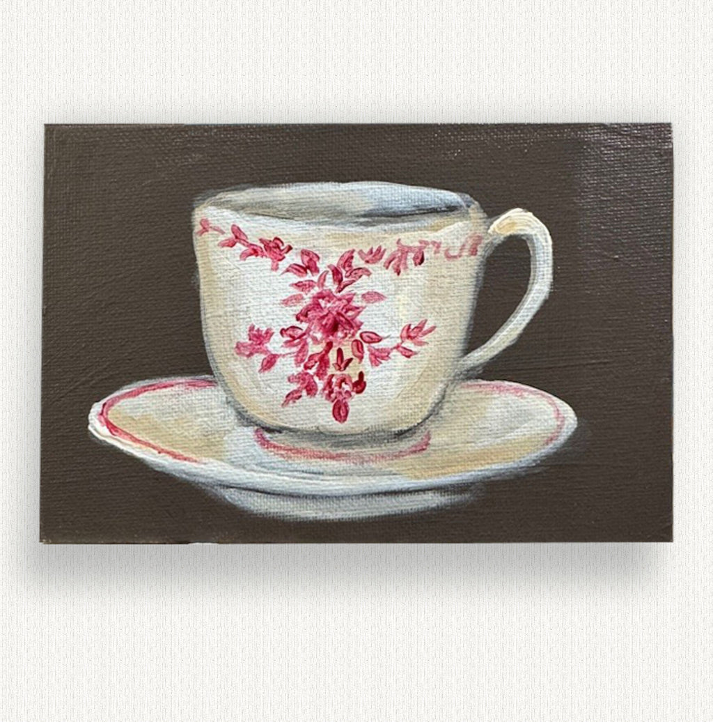 Painting of a floral teacup and saucer on a brown background