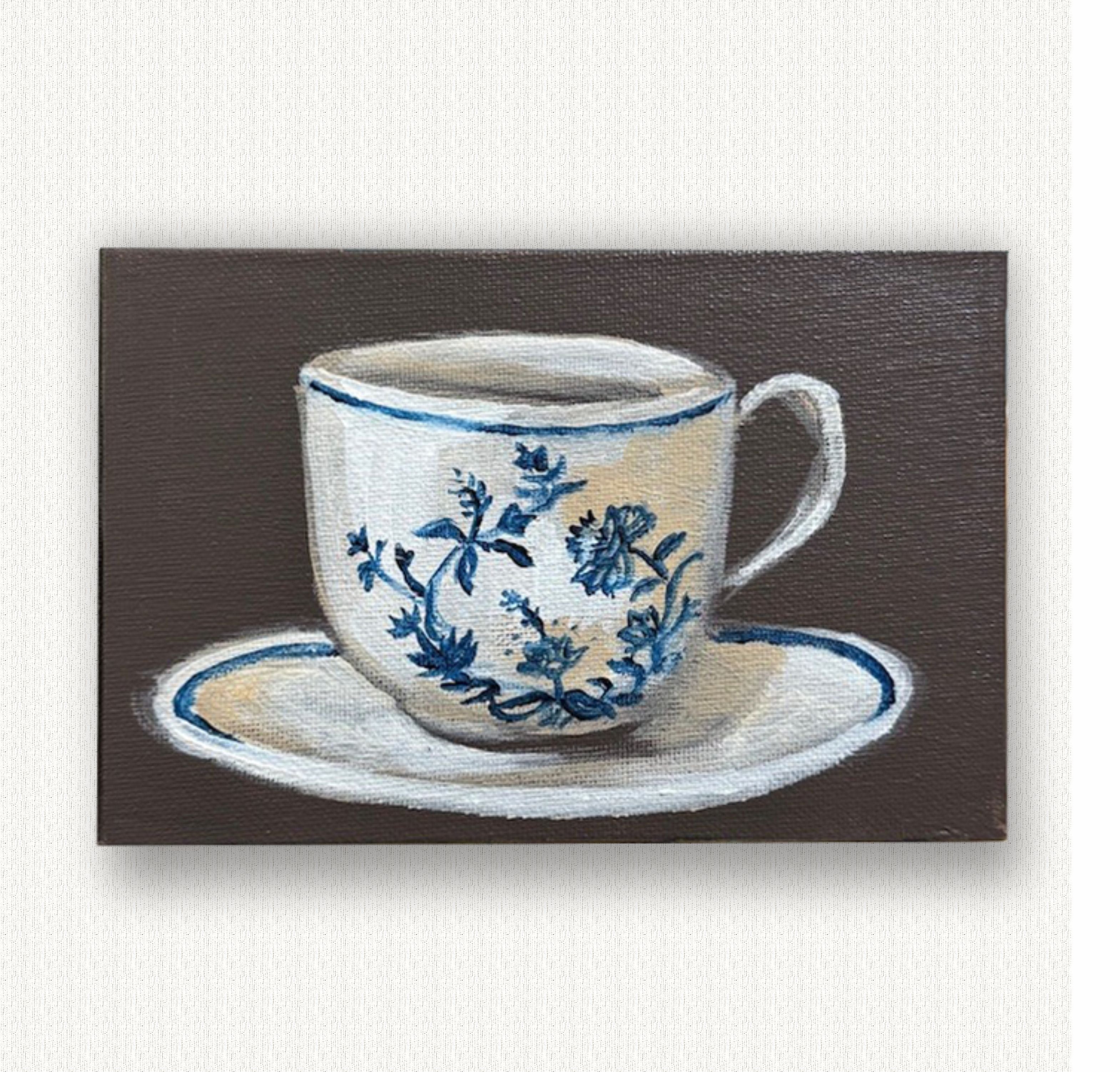 Painting of a white teacup with blue floral patterns on a brown background