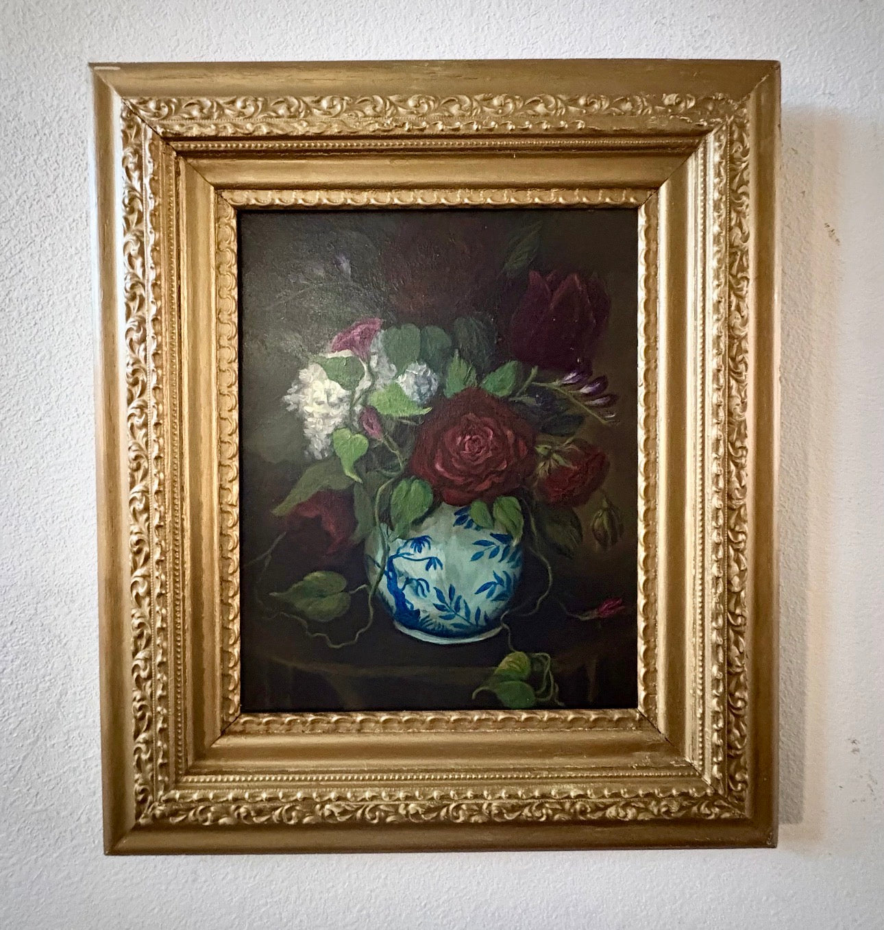 Original floral still life painting of roses in blue and white vase emerging from shadow in soft chiaroscuro light
