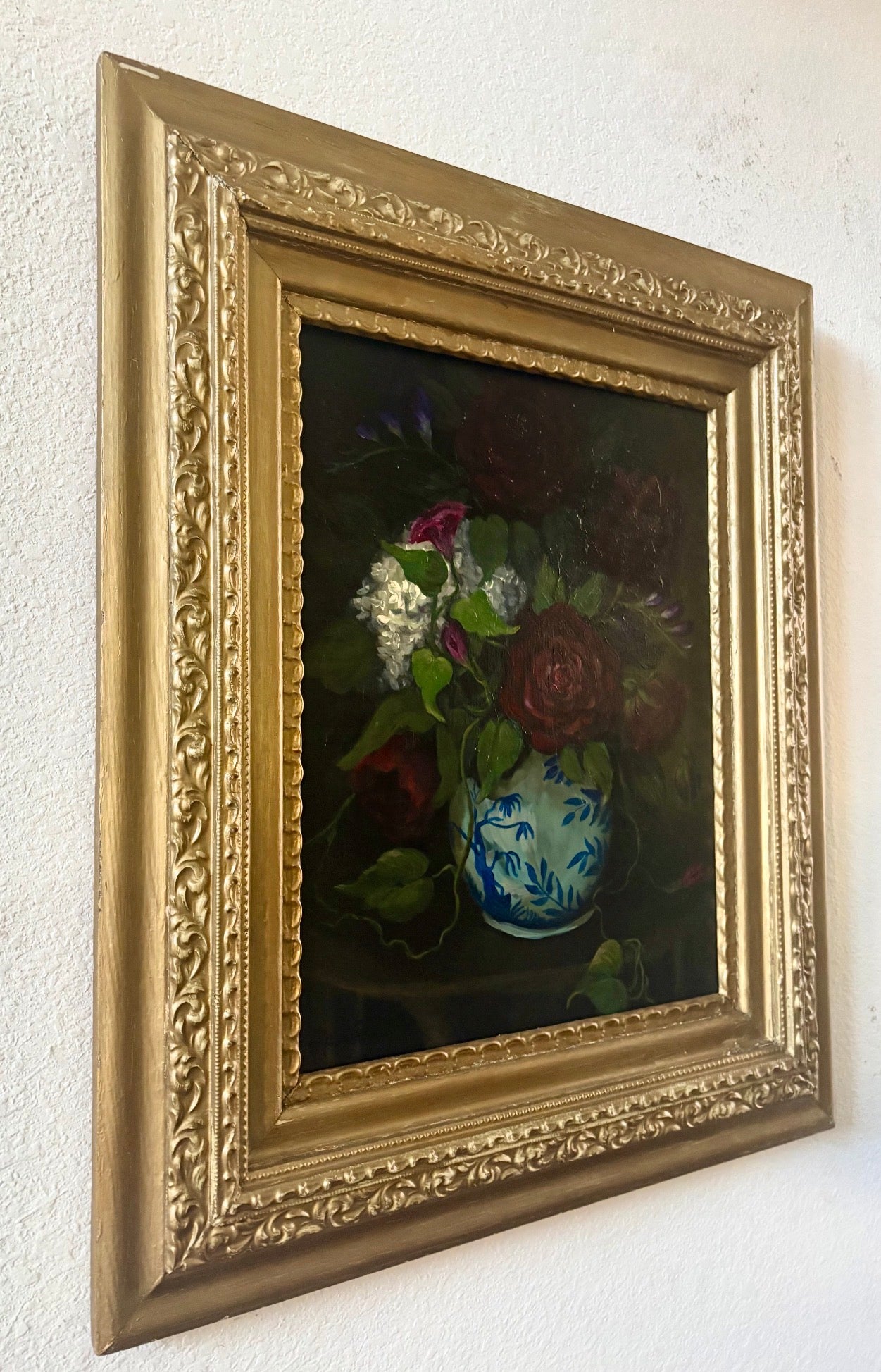Original floral still life painting of roses in blue and white vase emerging from shadow in soft chiaroscuro light
