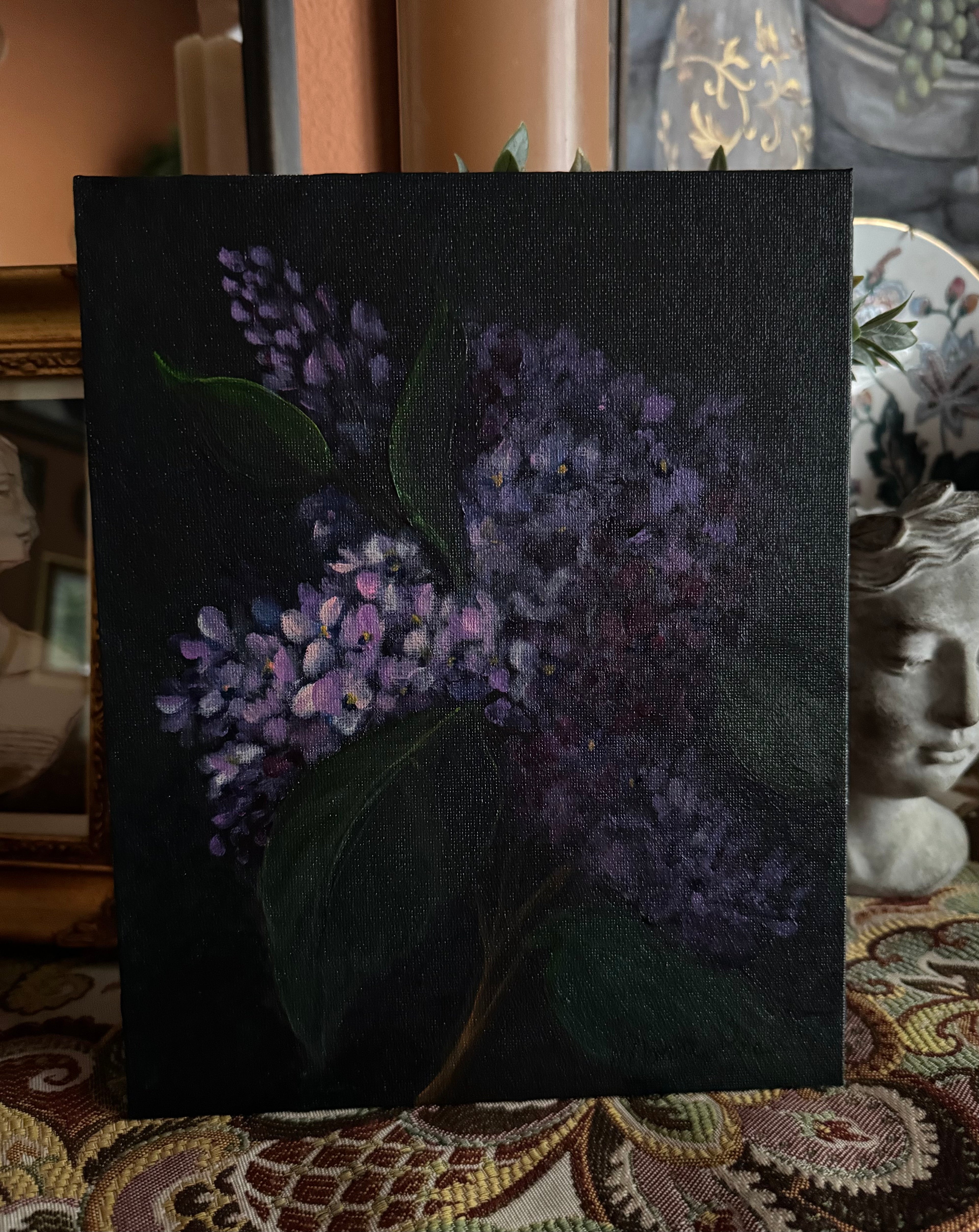 Original lilac painting with purple flowers and green leaves in soft chiaroscuro light